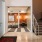 a room with a staircase and glass doors