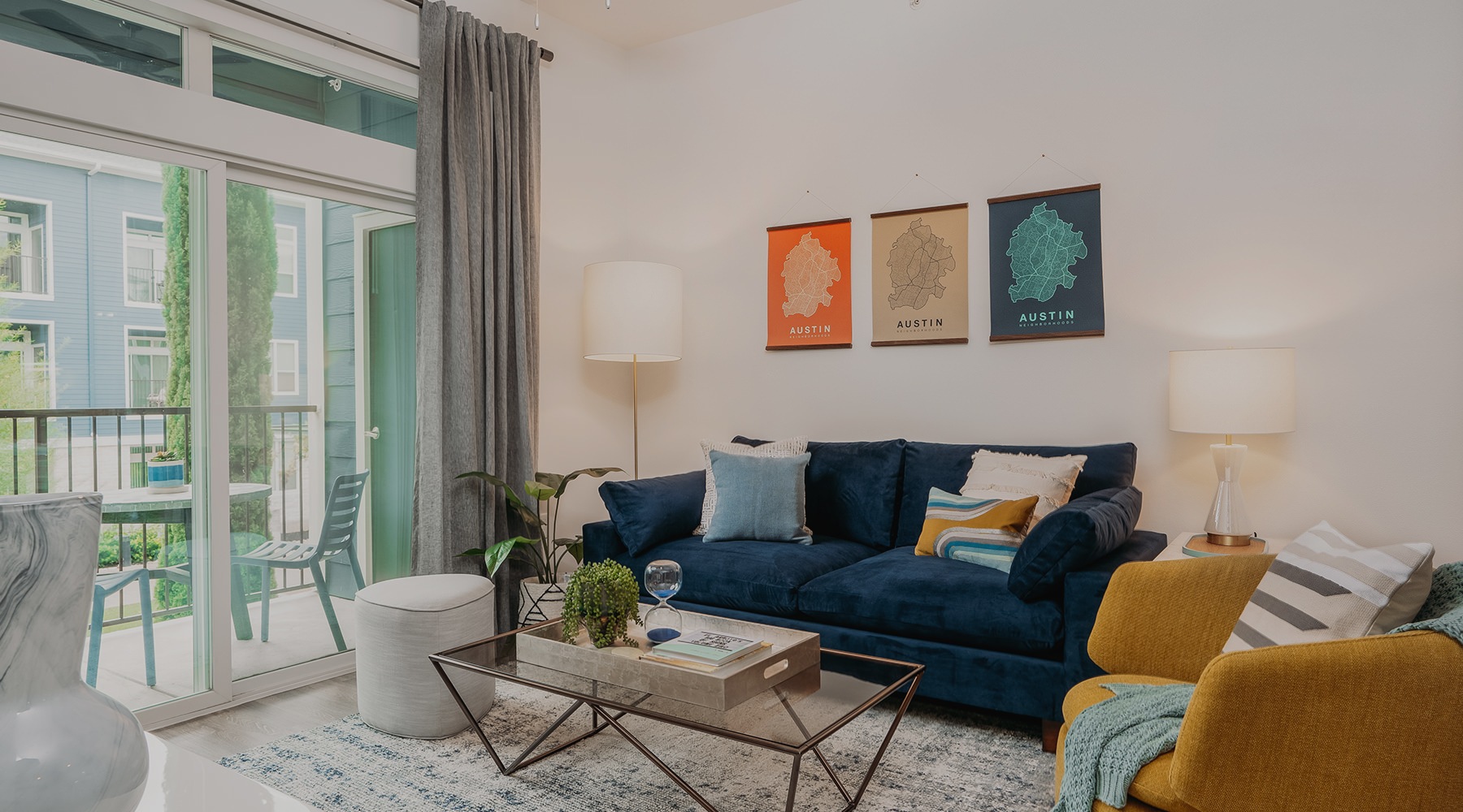 Cozy living room with patio access at Lakeshore Pearl Austin apartments for rent.