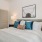 a bed with pillows and lamps